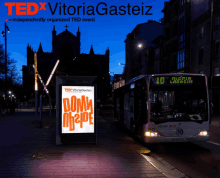 a tedx vitoriagasteiz poster with a bus in the background