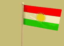 a red white and green kurdish flag with a yellow sun on it