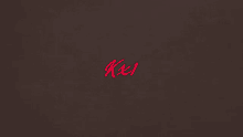 a red letter k is on a dark brown background