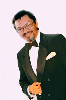 a man in a tuxedo with a bow tie and glasses