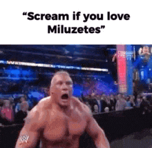 a man without a shirt is screaming in front of a crowd while wearing a wrestling ring .