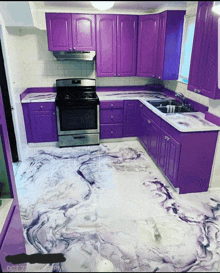 a kitchen with purple cabinets and marble floor