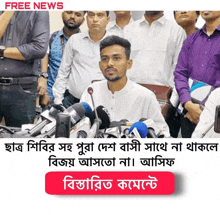 a man stands in front of a bunch of microphones with the words free news written above him