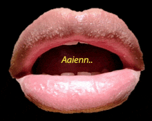 a close up of a person 's mouth with the word aaienn written in yellow