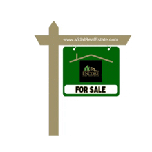 a for sale sign with the website www.vidalrealestate.com underneath it