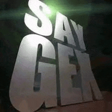 a large silver sign that says `` say gen '' is sitting on a table .