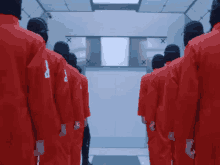 a row of men in red uniforms with the letter p on the back