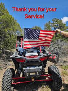 a man holds an american flag in front of a polaris atv