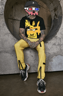 a man wearing yellow pants and a black shirt with a cartoon dog on it