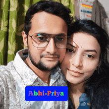 a man and a woman are posing for a picture with the name abhi-priya on the bottom right