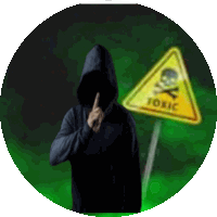 a man in a black hoodie is standing in front of a toxic sign