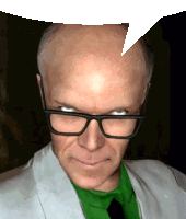 a man wearing glasses and a green shirt has a white speech bubble above his head