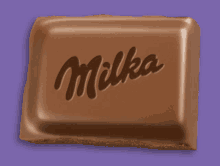 a milka chocolate bar is against a purple background