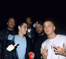 a group of men are posing for a picture and one of them has a la hat on