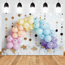 a bunch of colorful balloons are arranged in a rainbow shape