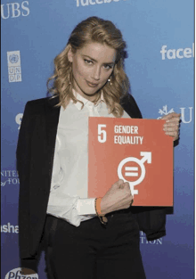 a woman holding a sign that says 5 gender equality