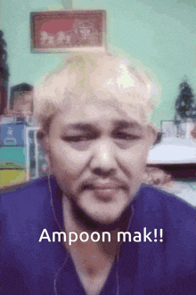 a man with blonde hair and a beard says " ampoon mak "