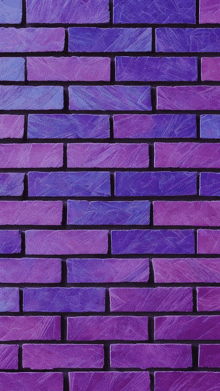 a brick wall with purple and blue bricks painted in different shades