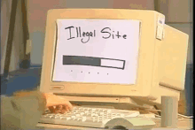 someone is typing on a keyboard in front of a computer monitor that says illegal site on it