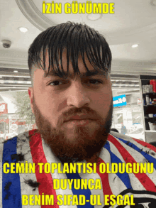 a man with a beard is wearing a striped shirt that says " benim sifad-ulesgal "