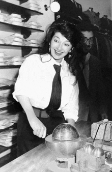 a black and white photo of a woman holding a globe