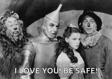 a black and white photo of the wizard of oz characters with a caption that says i love you be safe