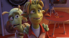 two green cartoon characters are standing next to each other and one has a red shirt on