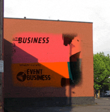 a brick building with a mural that says event business on it