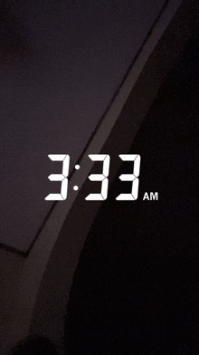 a digital clock reads 3:33 am on a black background