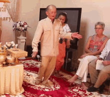 a man is dancing in front of a group of people in a room with a sign that says mary