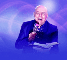 a man is holding a book and a microphone in front of a purple background with the word approve on it