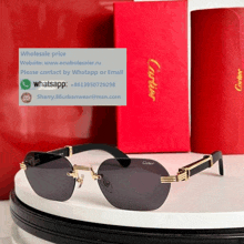 a pair of cartier sunglasses sitting on a table next to a red box