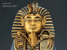 a statue of a man with glasses and a blue and gold headpiece is made with the reface app