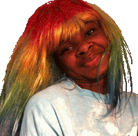 a woman wearing a rainbow colored wig and a blue shirt smiles