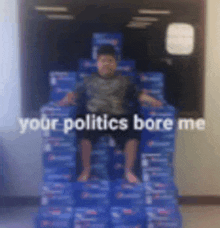 a boy is sitting on top of a stack of pepsi boxes