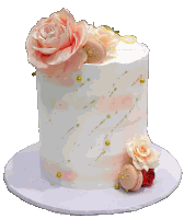 a white cake with pink roses and macarons on top