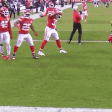 a group of football players are standing on a field and one of them has the number 22 on his jersey