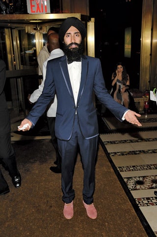 Image may contain Waris Ahluwalia Clothing Apparel Human Person Coat Suit Overcoat Face and Tuxedo