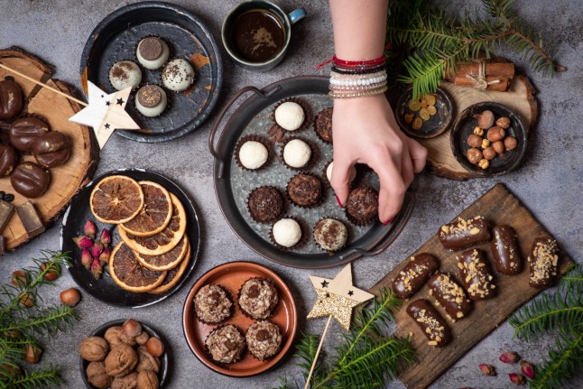 Woman serving luxurious, homemade chocolate praline candies