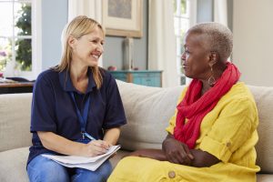 Female Support Worker Visits Senior Woman At Home