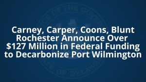 Graphic with blue background and Delaware State Seal that says "Carney, Carper, Coons, Blunt Rochester Announce Over $127 Million in Federal Funding to Decarbonize Port Wilmington"