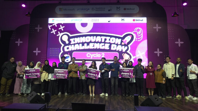 A group of young Indonesians are smiling on stage after winning the Innovation Challenge Day. They are posing with their winning plaques.