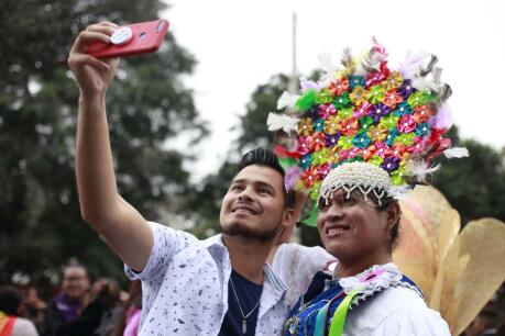 Cute boy taking a selfie with a Peruvian drag during gay pride in Lima