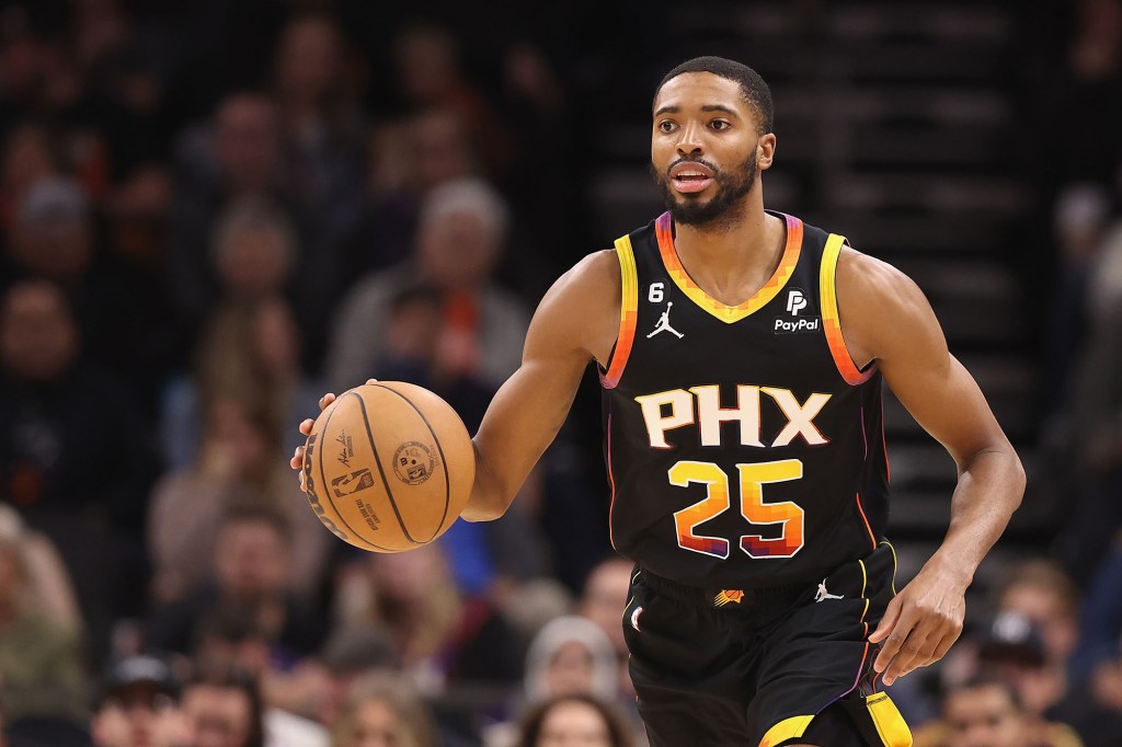 Mikal Bridges handles the ball during the second half of the NBA game at Footprint Center.