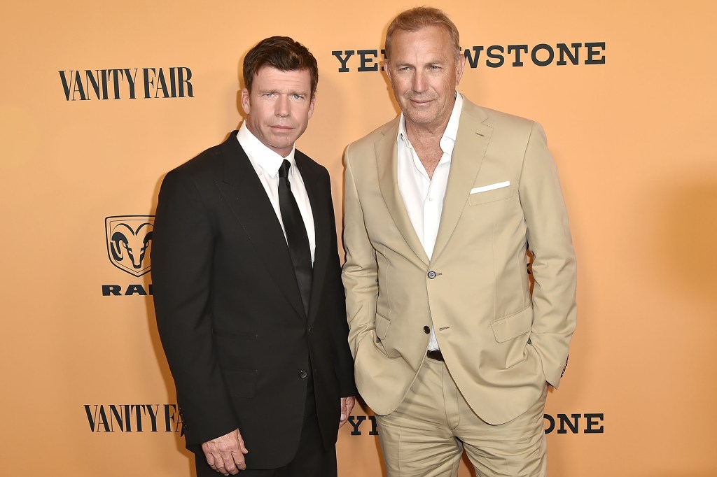 Taylor Sheridan and Kevin Costner smiling next to each other. 