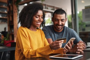 A woman uses her credit card to purchase online items.