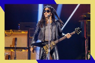 Lenny Kravitz rocks out on guitar while onstage.