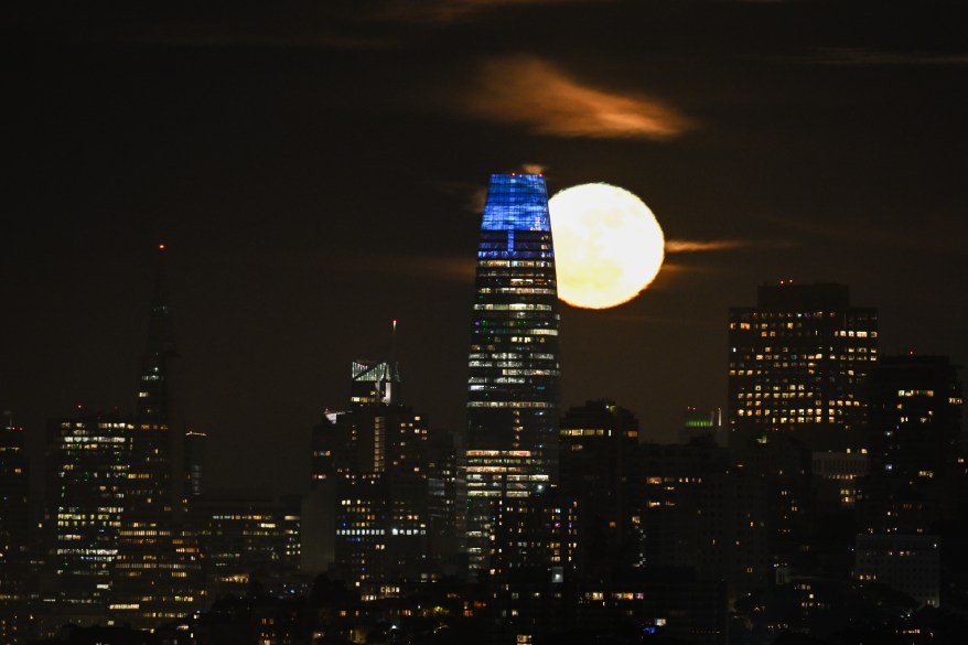 The Full Flower Moon rises behind Salesforce Tower in San Francisco.