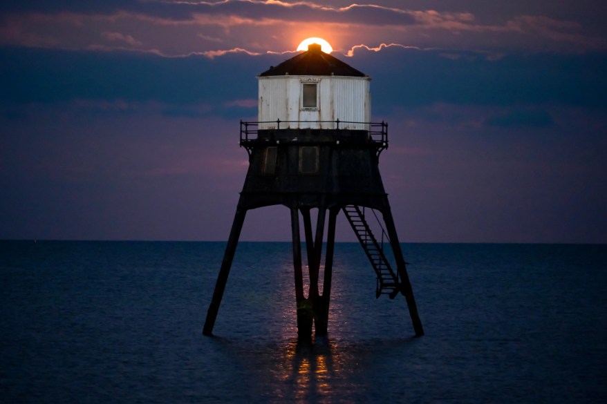 Flower Moon rises over the Dovercourt Lower Lighthouse, Essex, UK.