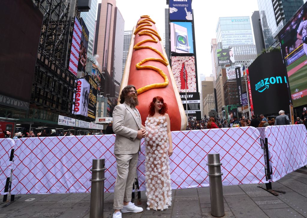 The creators of the hot dog with their creation.